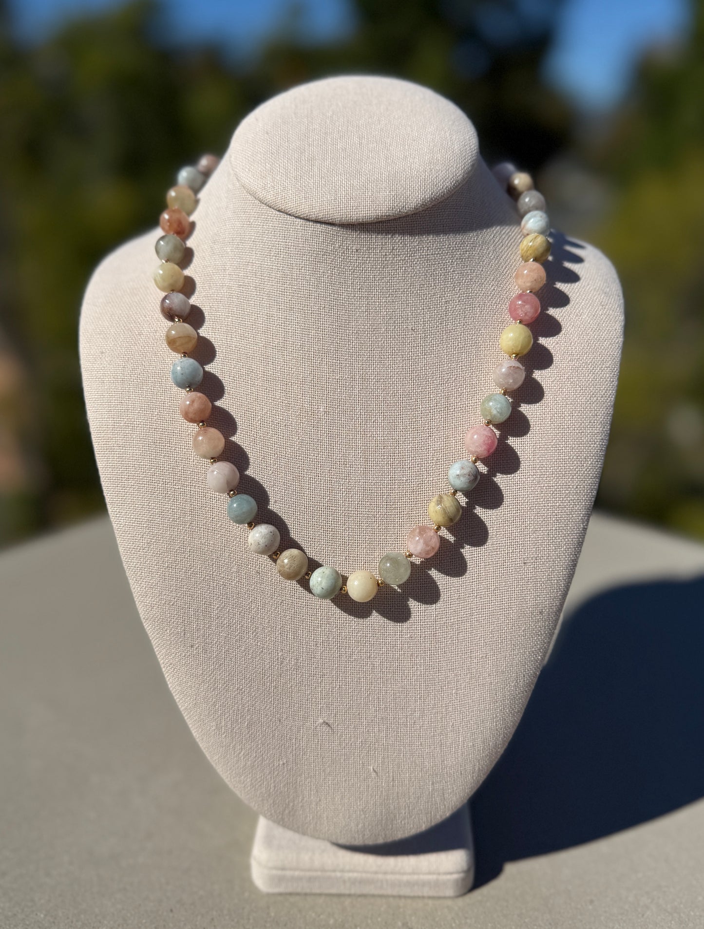 Multicolor beryl morganite necklace, hand-knotted with gold-plated clasp, 20 inches long.