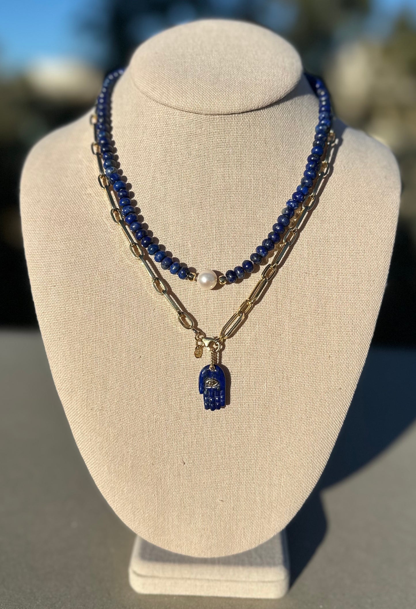 Lapis and pearl necklace shown with separate gold chain and charm for styling, charm and chain not included.