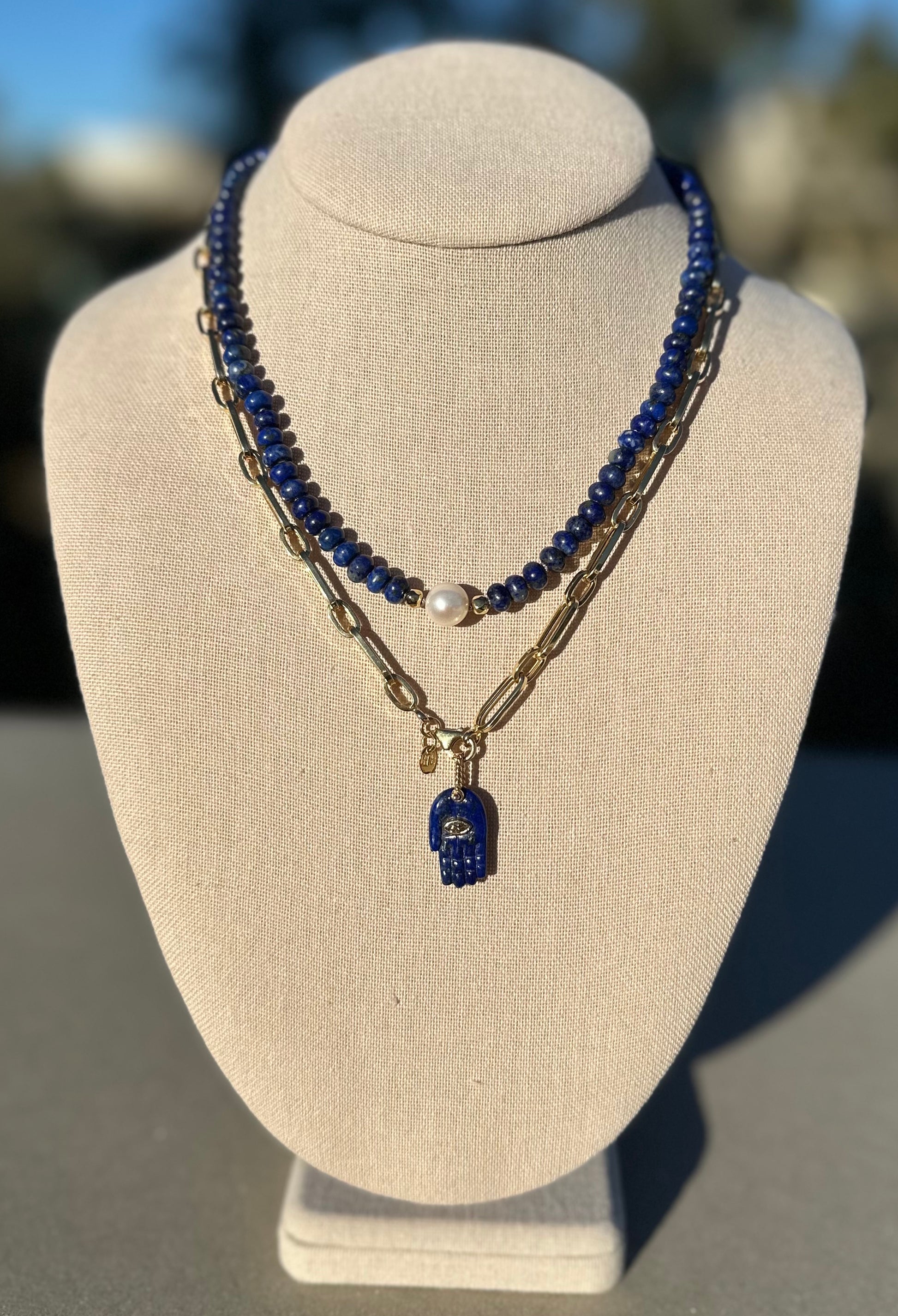 Lapis and pearl necklace shown with separate gold chain and charm for styling, charm and chain not included.