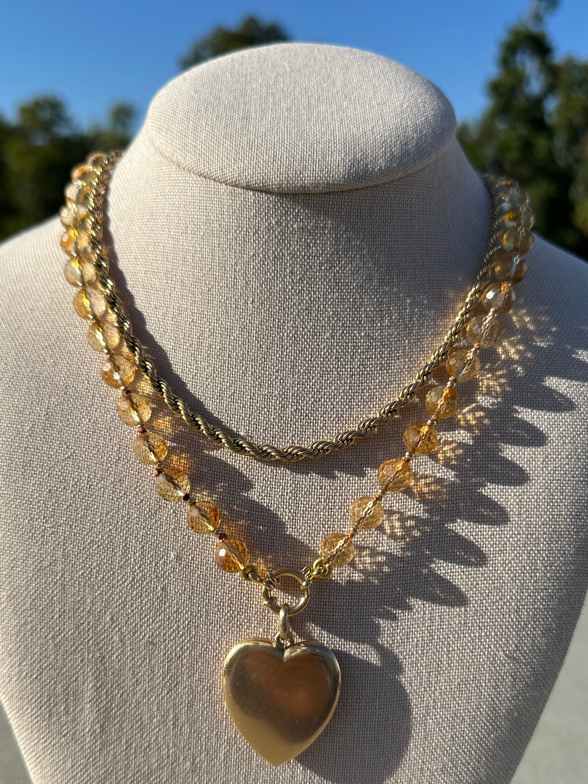 Close-up of 8 mm citrine beads and gold-plated accents showing faceted surface and color variation.