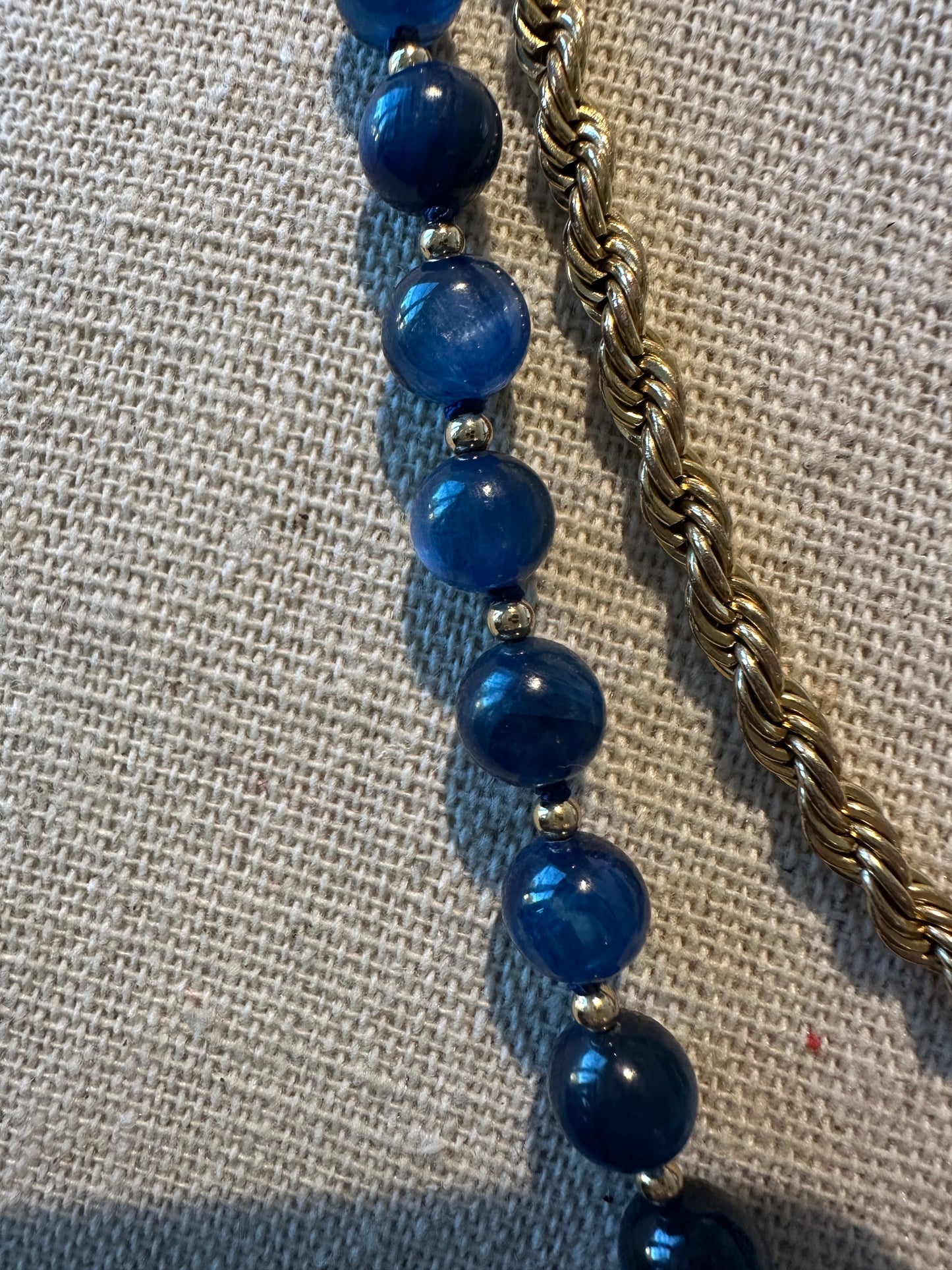 Detail view of kyanite bead surface texture and color variation on hand-knotted strand.