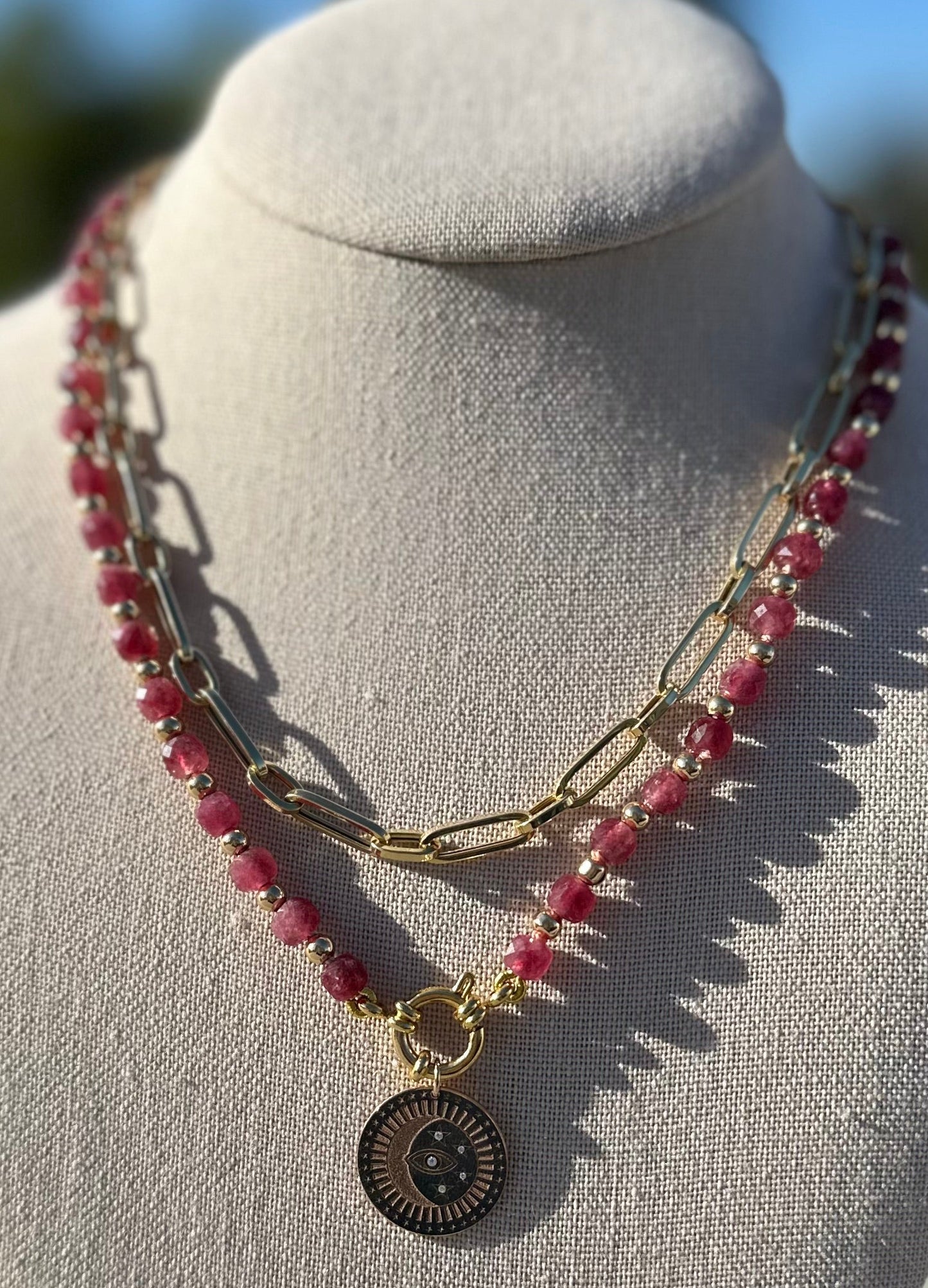 Close-up of ruby and gold-plated beads showing 6 mm faceted stone detail.