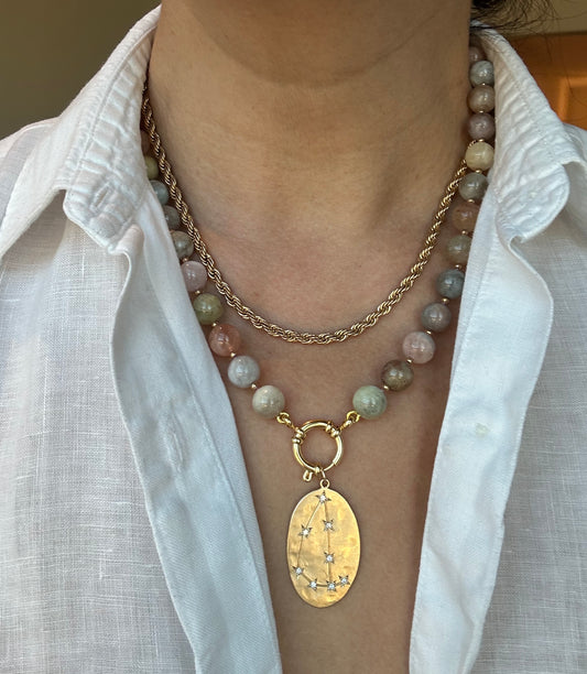 Person wearing multicolor beryl morganite necklace around neck, 20-inch strand length.