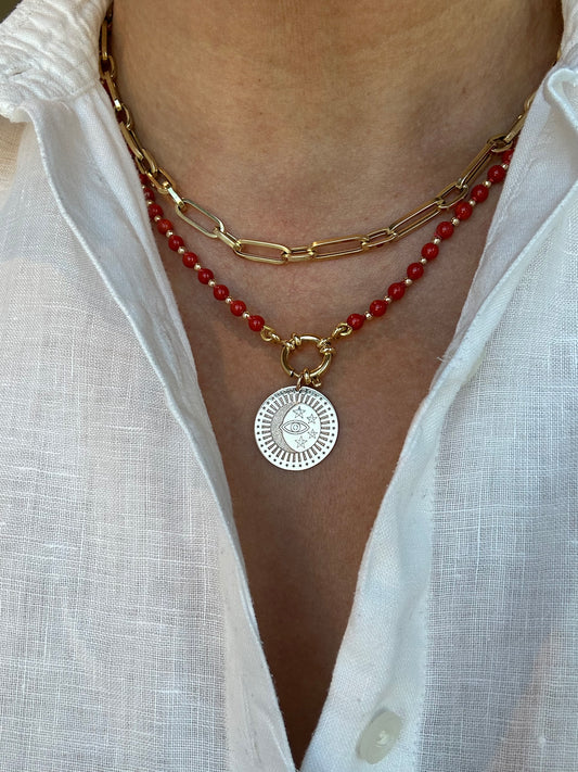 Person wearing coral beaded necklace around neck, 19-inch length shown.