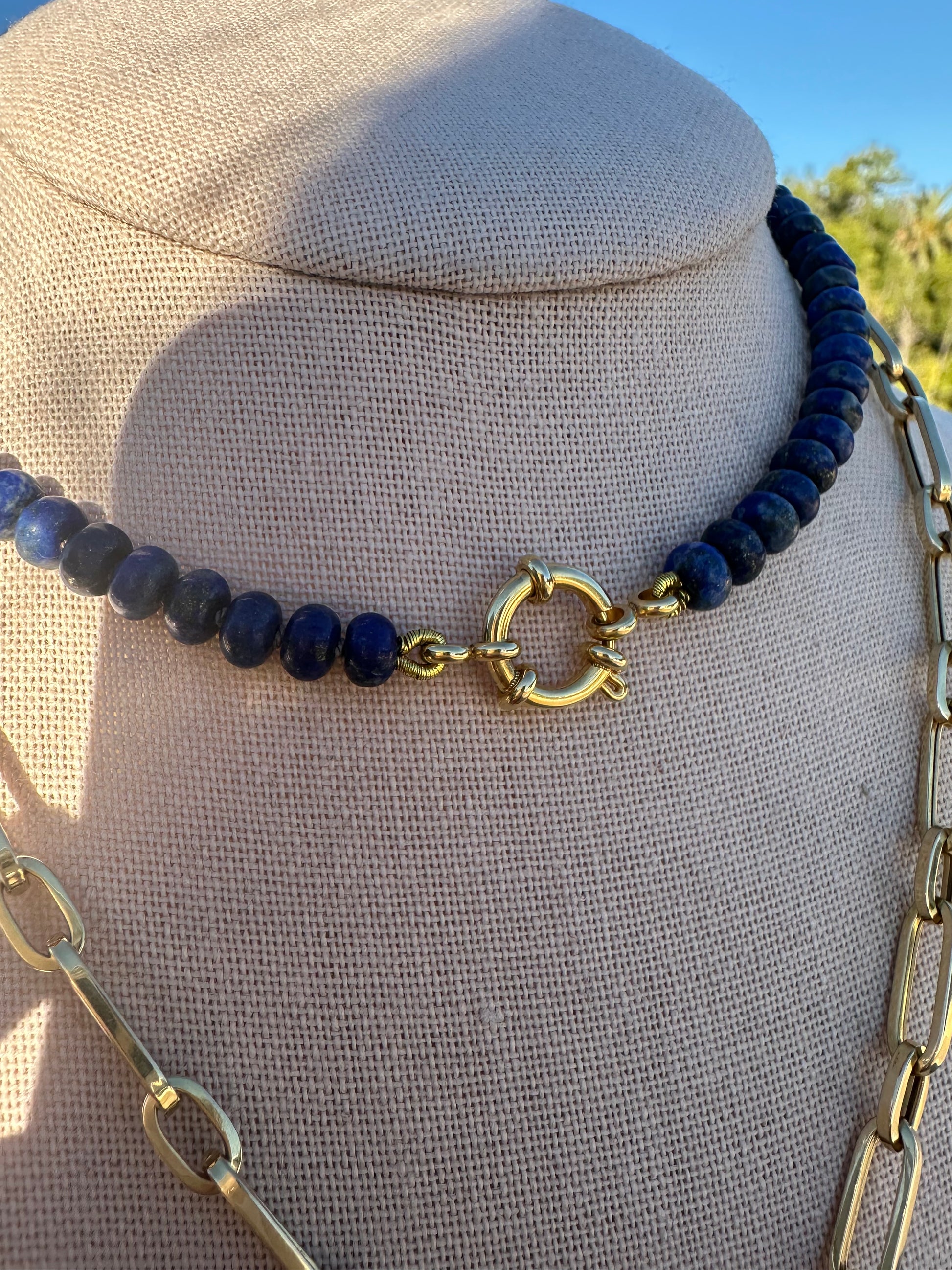 Rear view of lapis and pearl necklace displaying gold-plated clasp and connector rings.