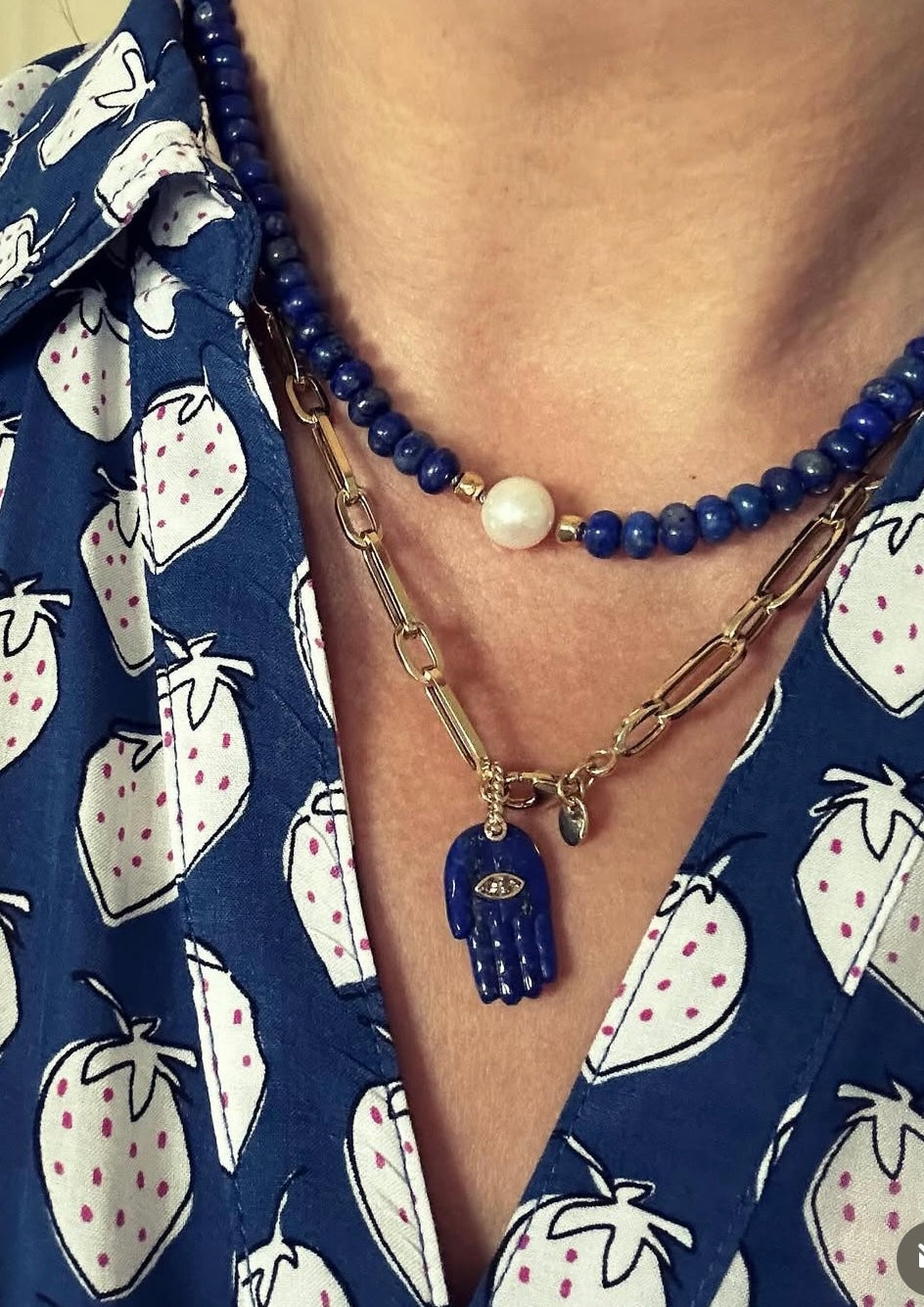 Person wearing lapis lazuli and freshwater pearl necklace around neck, 20-inch strand length.